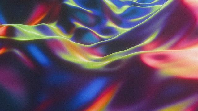 Vibrant neon colors create flowing, wave-like patterns with bright green, pink, and blue light streaks.